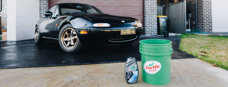 car in driveway bucket and car care kit product